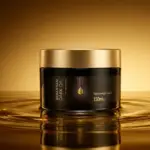 Banner de topo para artigo de resenha. Em destaque, o pote preto e dourado da Máscara de Nutrição Sebastian Dark Oil sobre um fundo com texturas de óleo dourado, ilustrando a nutrição profunda do produto.